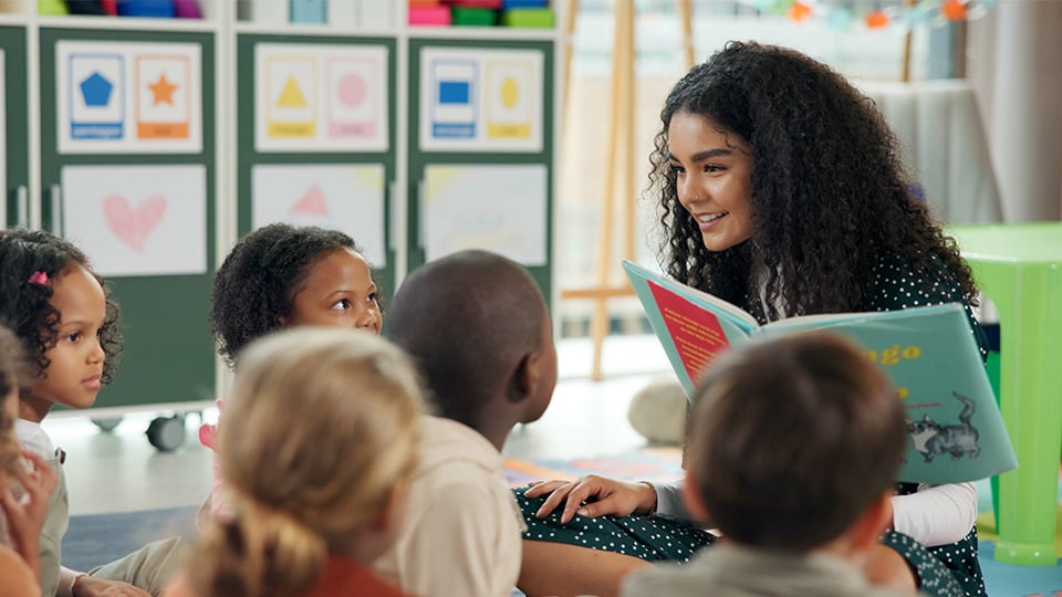 teacher-reading-book-to-elementary-class
