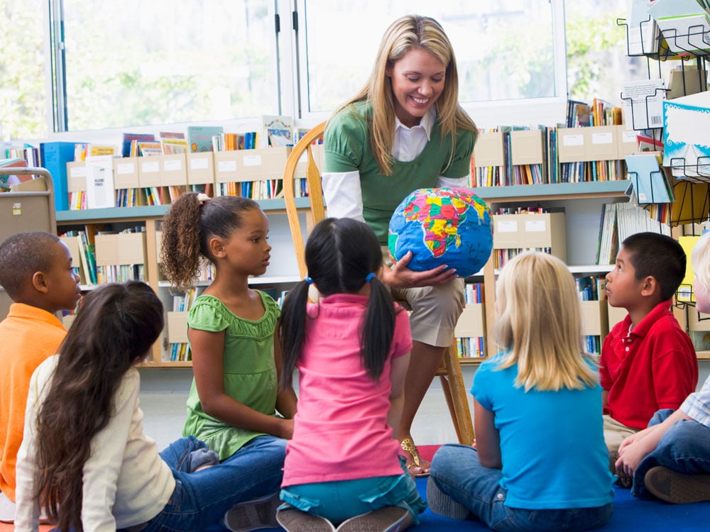 teacher-with-young-students-around-a-globe-4x3